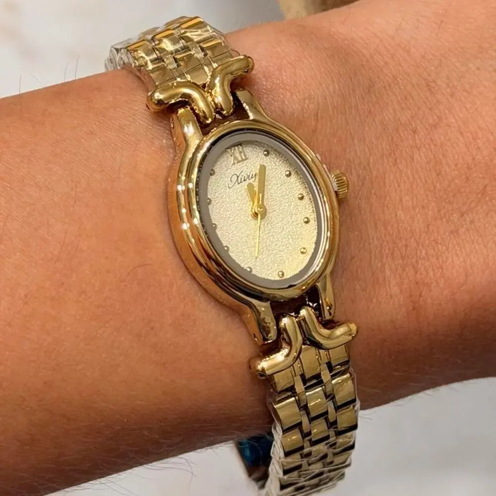 Gold watch with white face